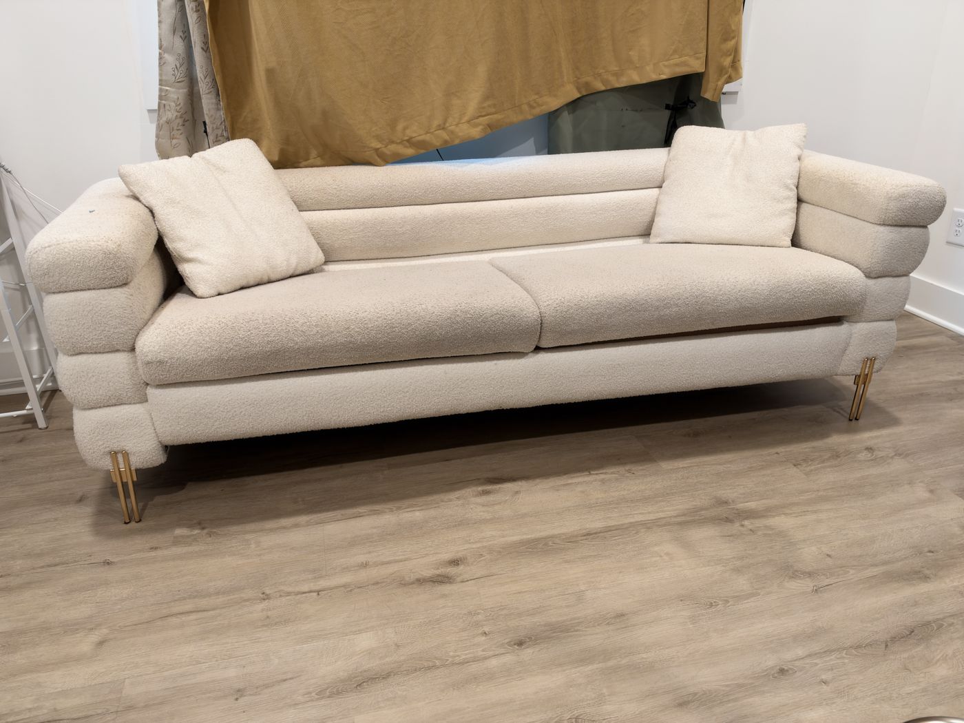 Cream boucle channel-tufted sofa with gold legs