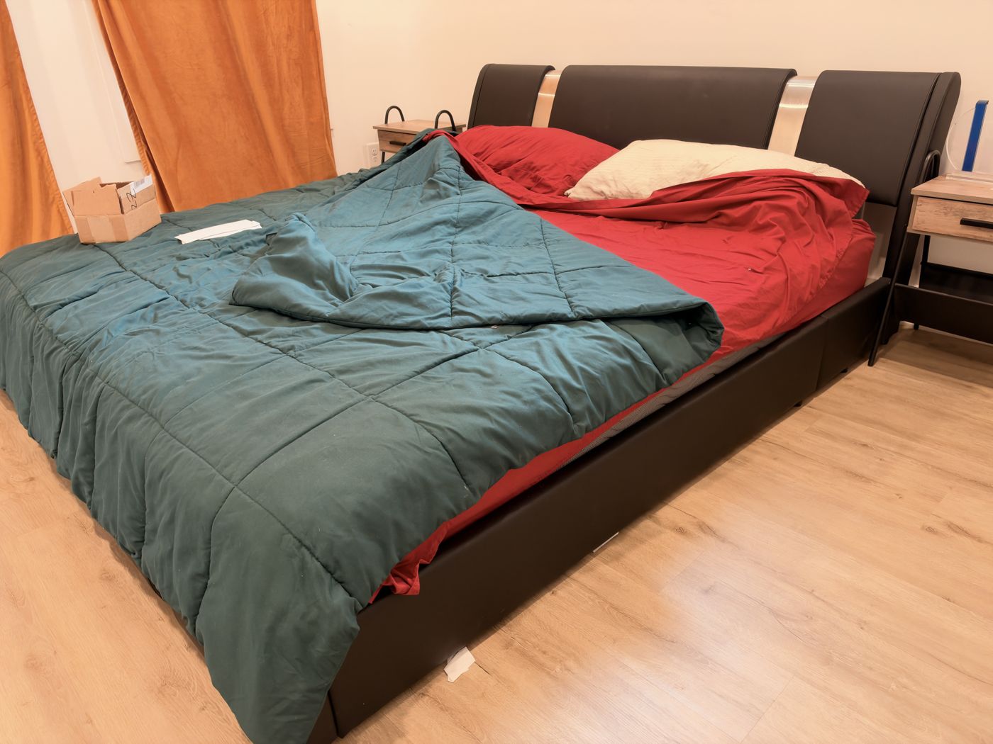 Black faux leather king platform bed with chrome headboard accents